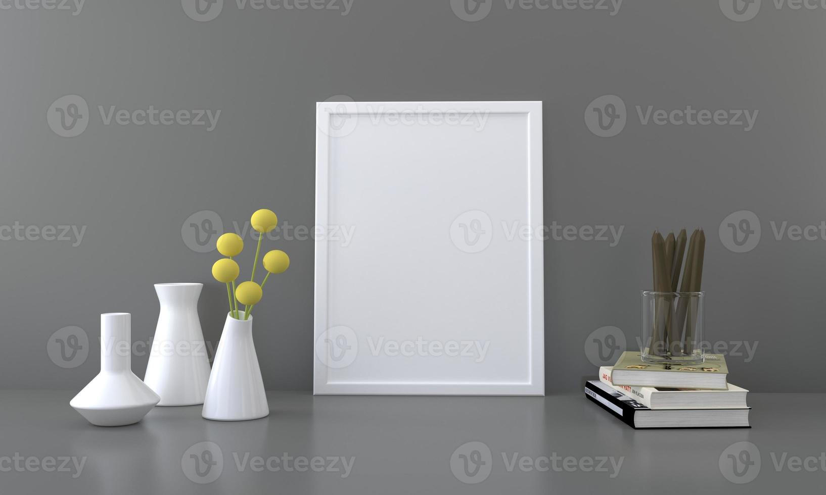 A blank picture frame with vases and books on a table photo