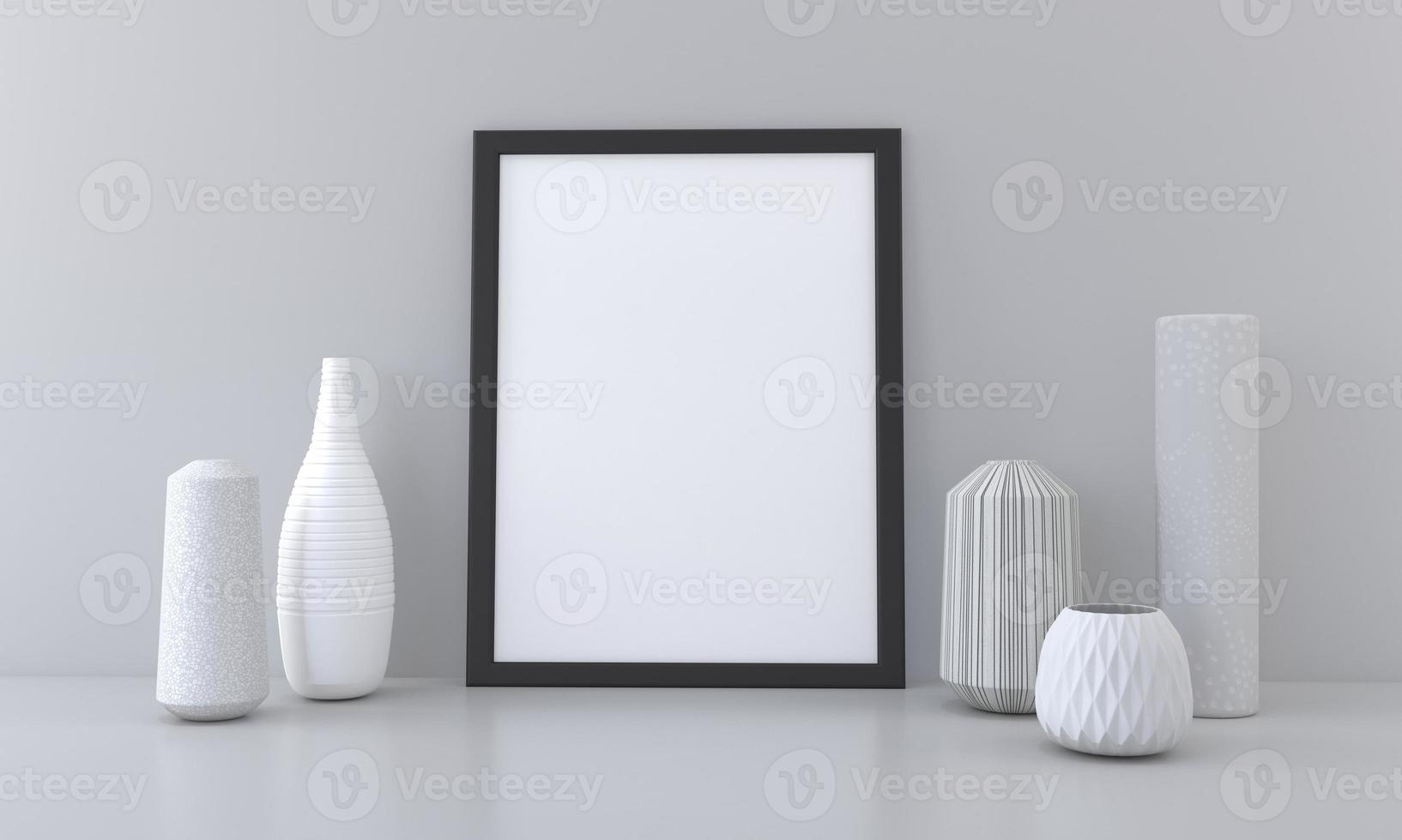 A blank picture frame and vases on a table photo