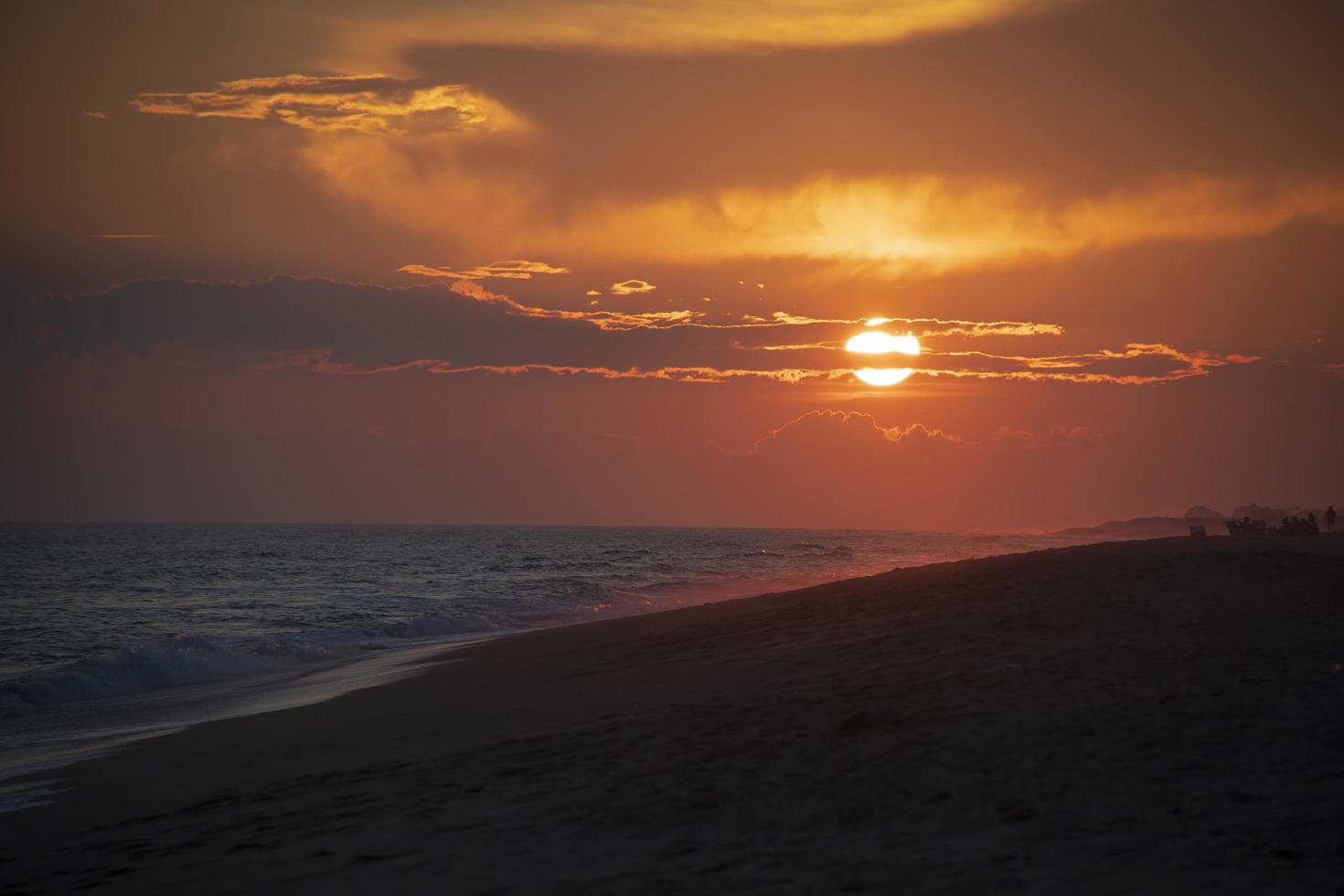 Beautiful sunset on the beach near the ocean photo