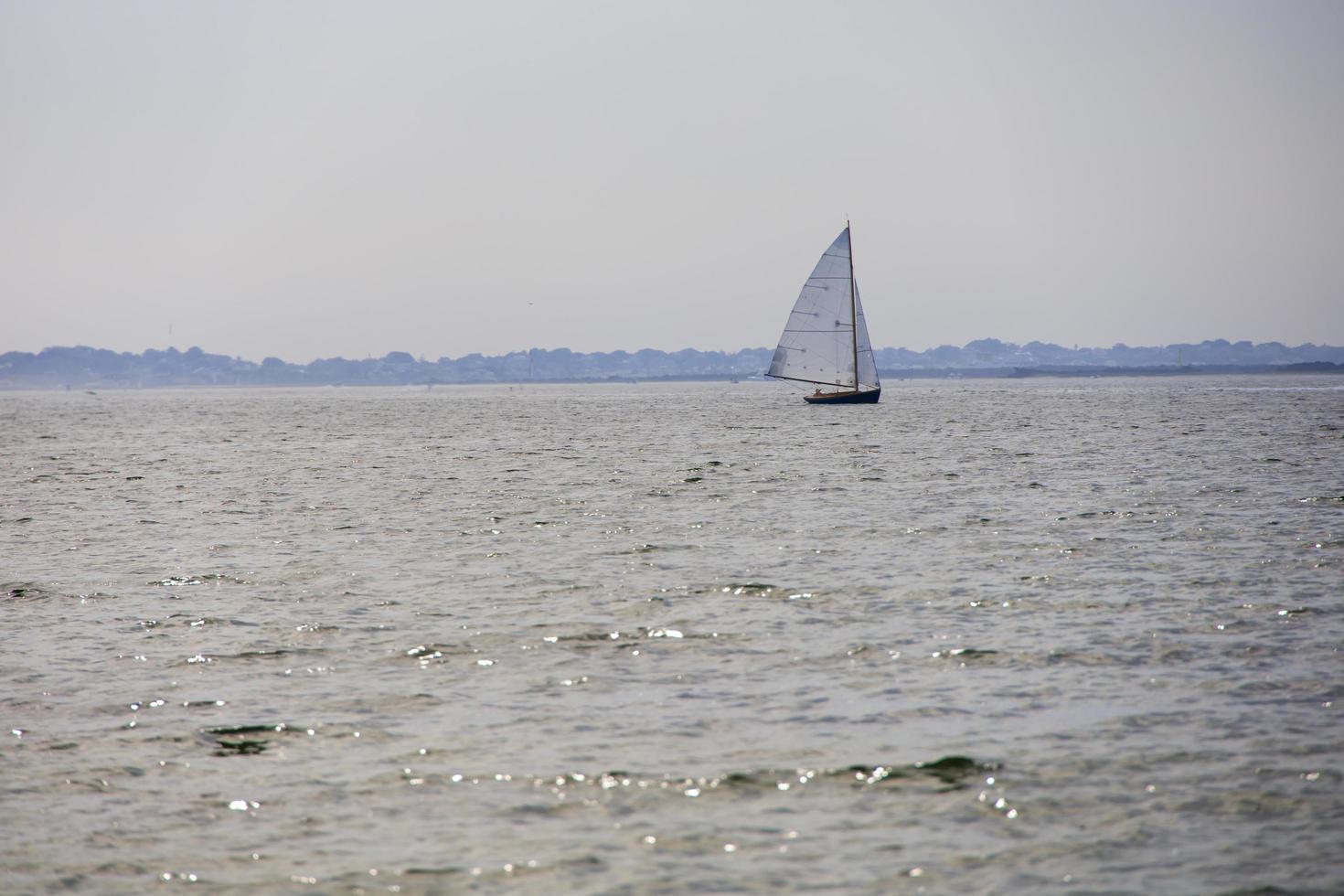 Sailboat sailing on the open ocean photo