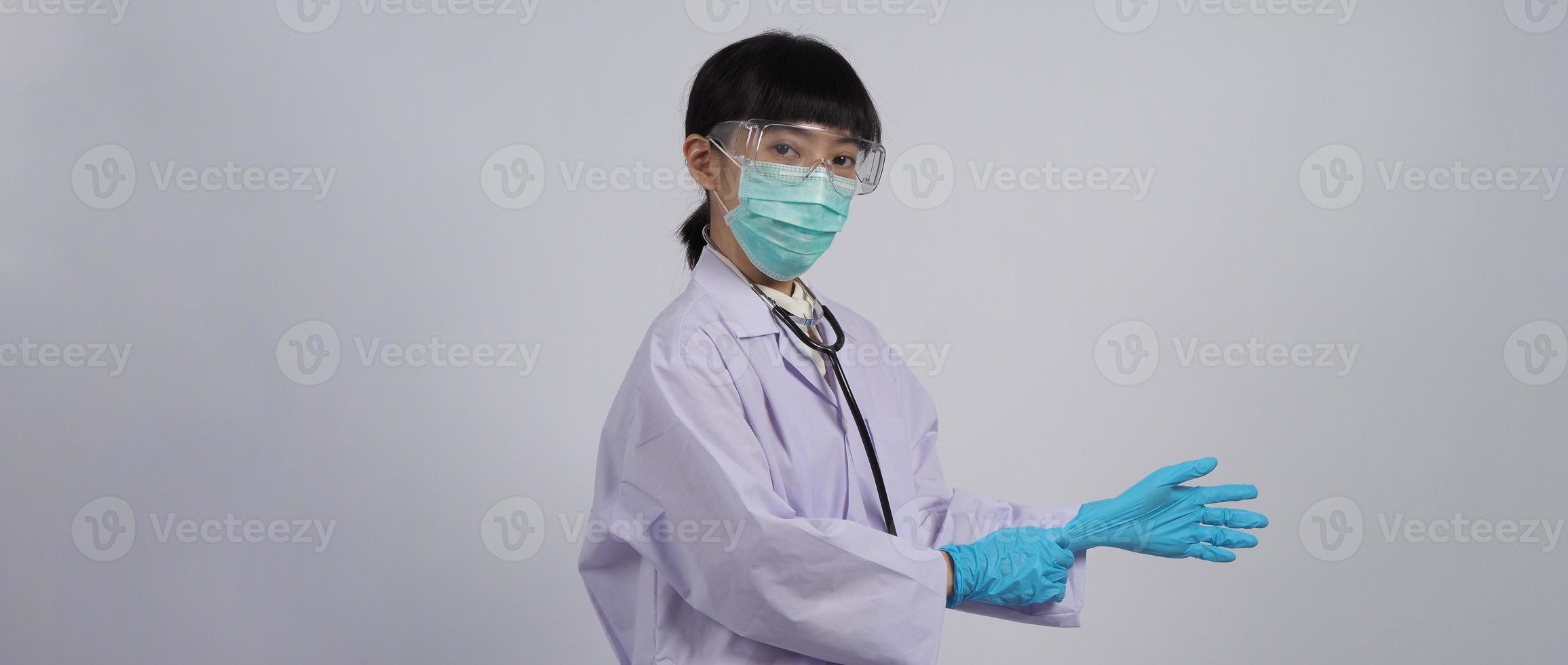 Wearing gloves. Asian doctor wear blue rubber nitrile hands glove. photo