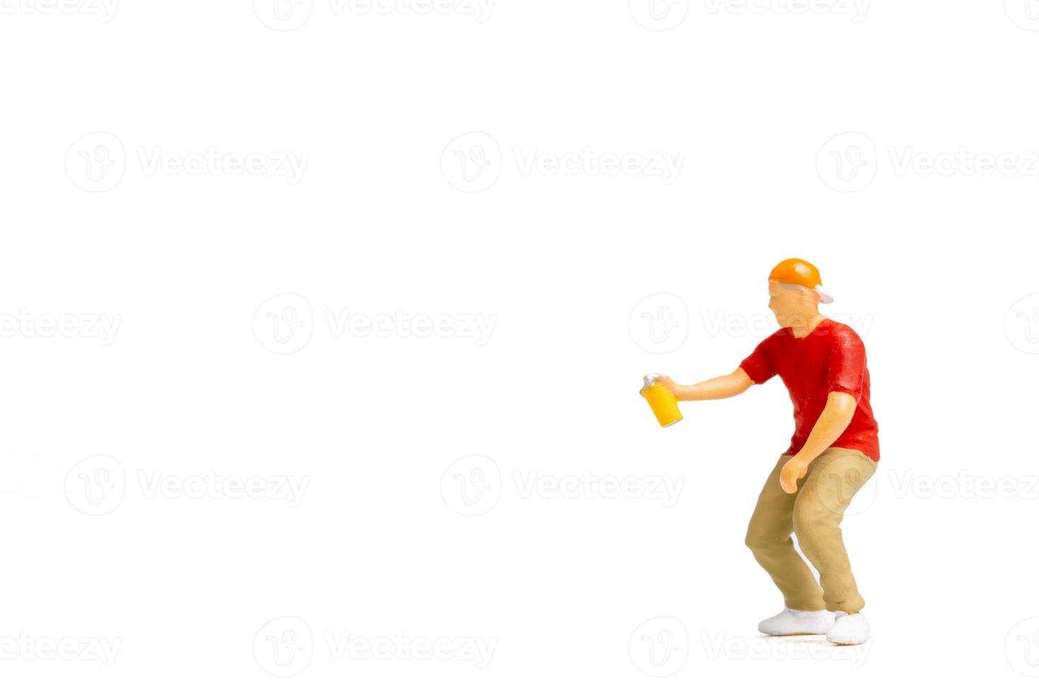 Miniature people Teenager spraying paint from can on white background photo