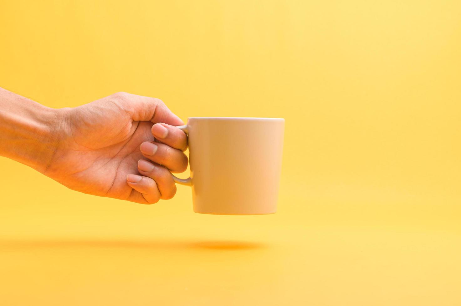 Hand holding a coffee cup, drinking coffee to give energy. photo