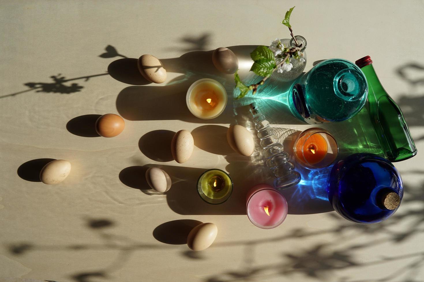 Easter Eggs And Decorative Colorful Glasses With Water On The Table. photo