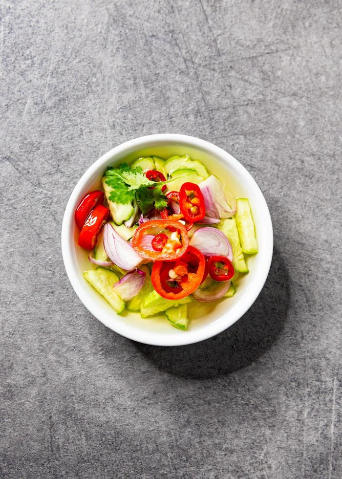 Cucumber slices chilli and onions in vinegar served with moo satay, asian food photo