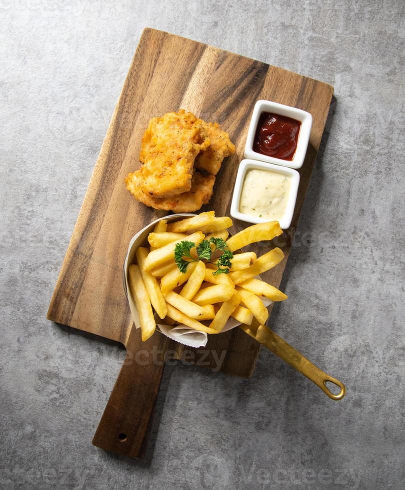 Traditional British Fish and Chips with french fries photo