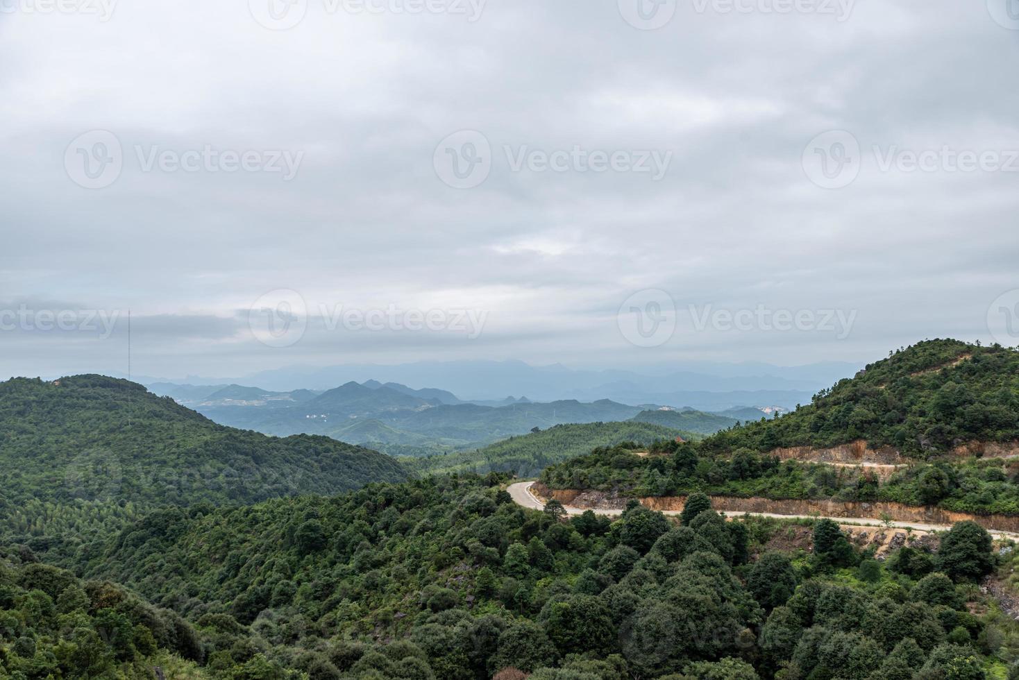 A country surrounded by forests on a cloudy day photo