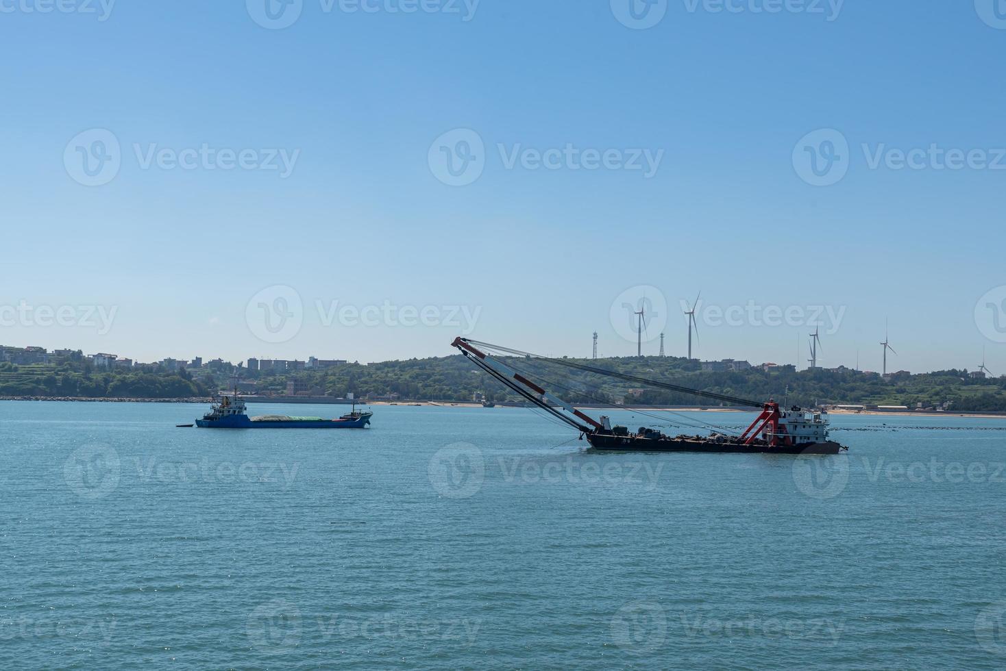 The ocean under the blue sky, the ship staying at the dock or the sea photo