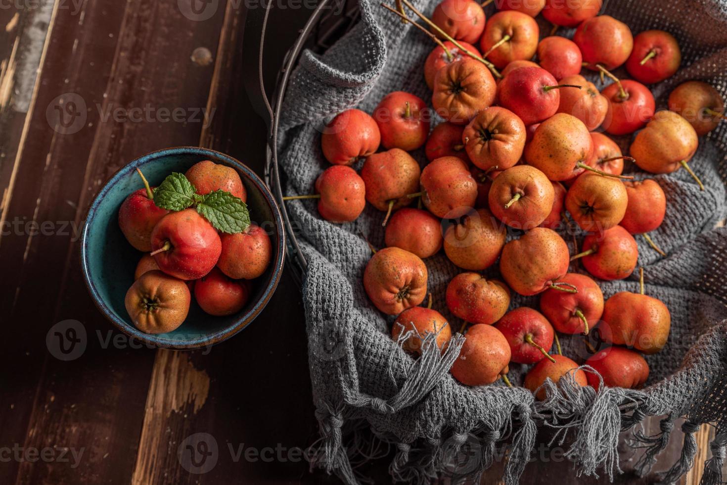 The raw hawthorn on the plate is on the wooden table photo