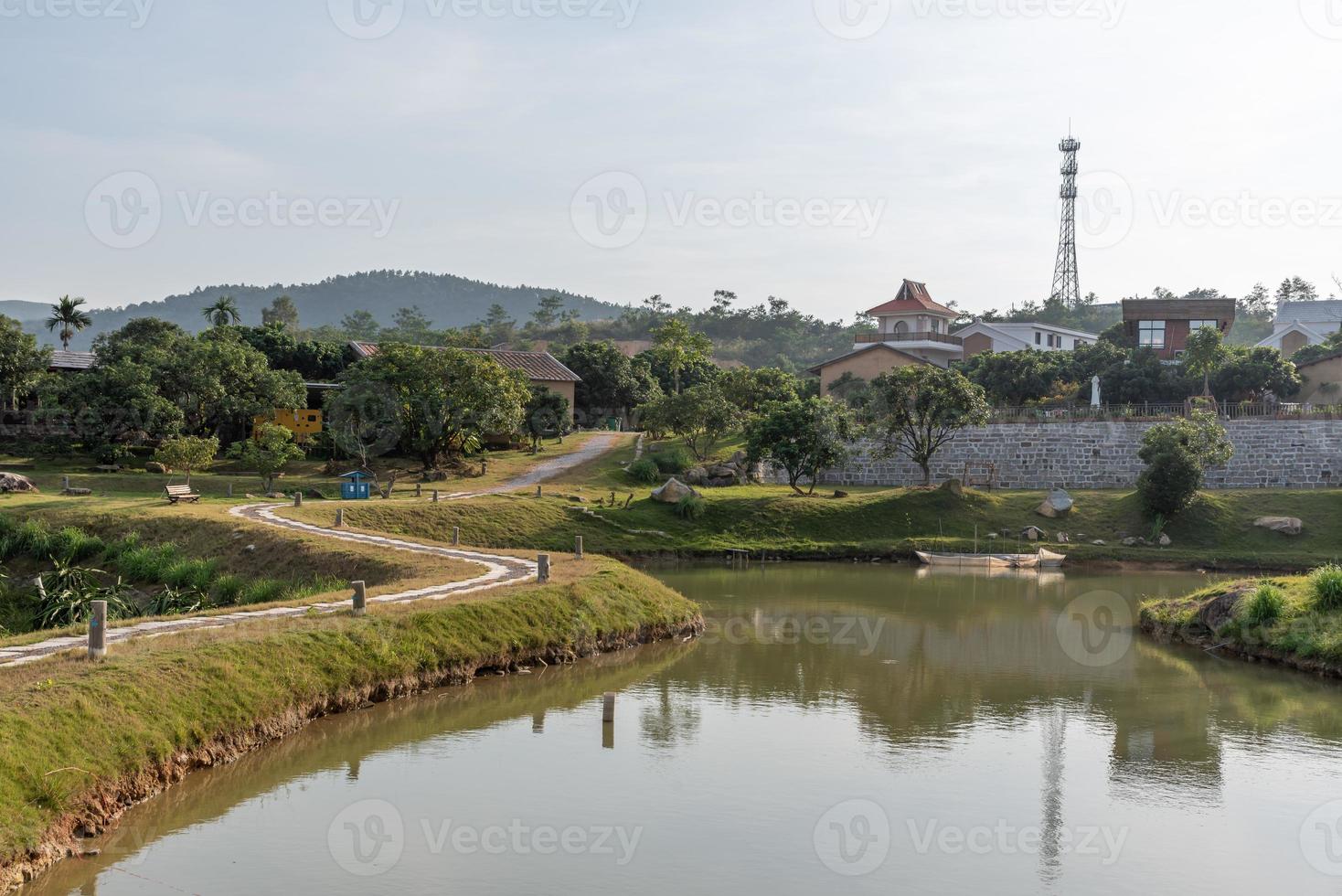 The artificial lake in the park and the roads and trees by the lake photo