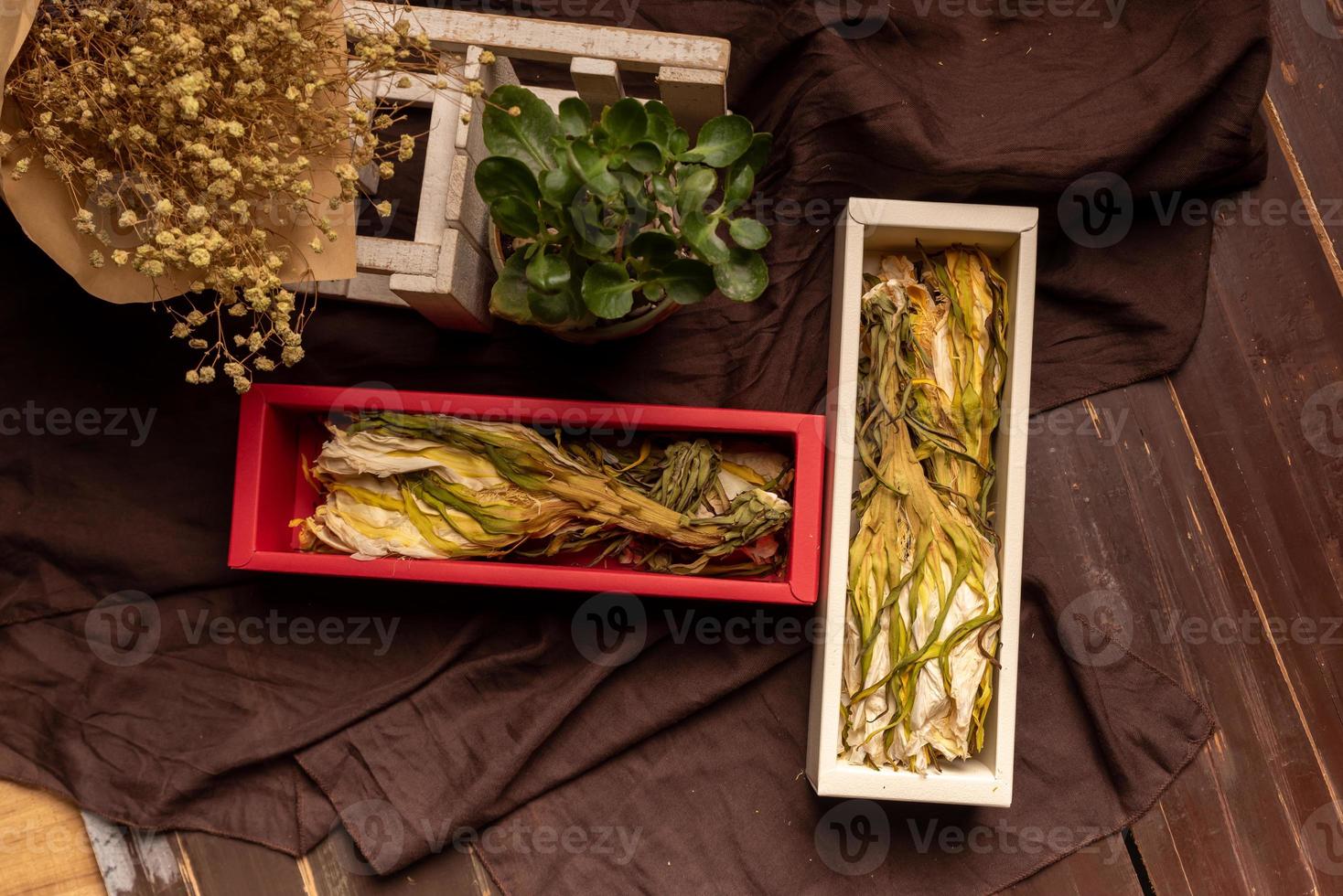 Dried pitaya flowers that can be used as food are on the wooden table photo