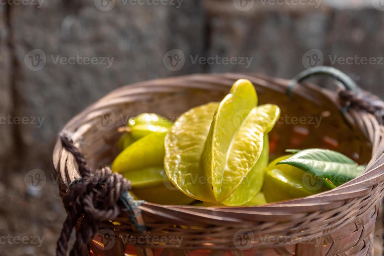 The Yellow carambola is ripe. Pick it and put it in the basket photo