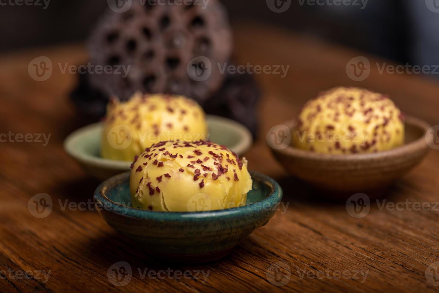 Cut and complete the egg yolk steamed stuffed bun on the wood grain table photo