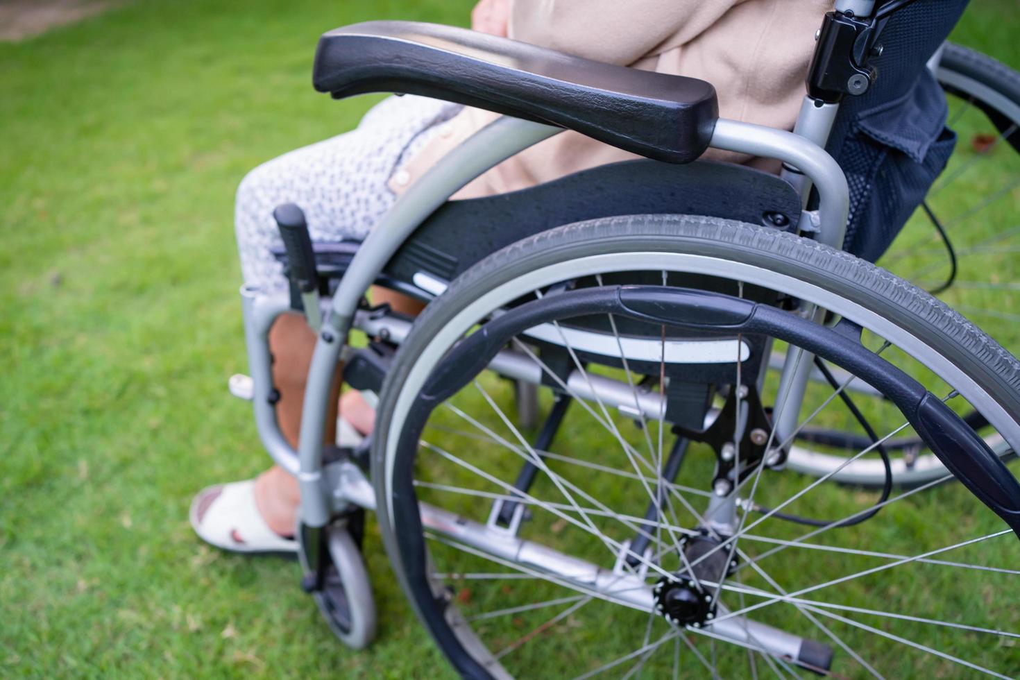 Asian senior or elderly old lady woman patient on wheelchair in park, healthy strong medical concept photo