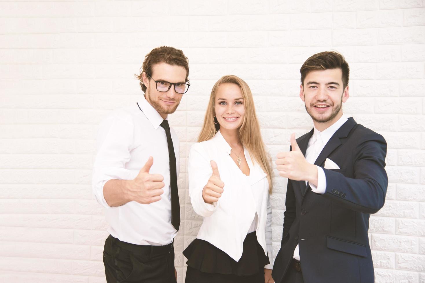 Team workers thumbs up for success in business in front of wall at cafe, Business and success concept, Teammate and Cooperation, Soft tone pinterest and instragram like process photo