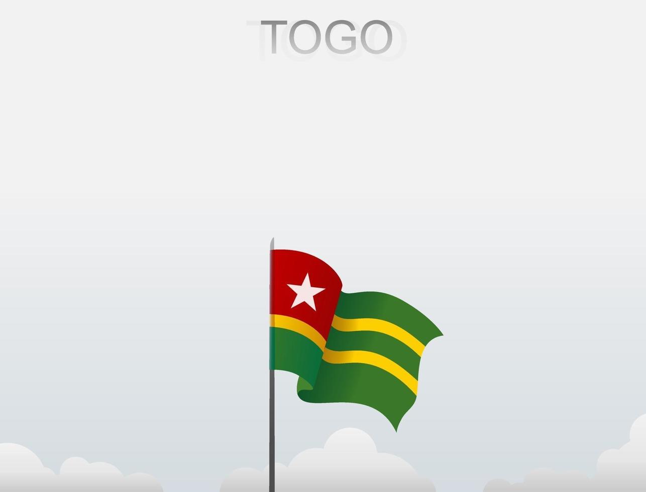 Flag of Togo flying under the white sky vector