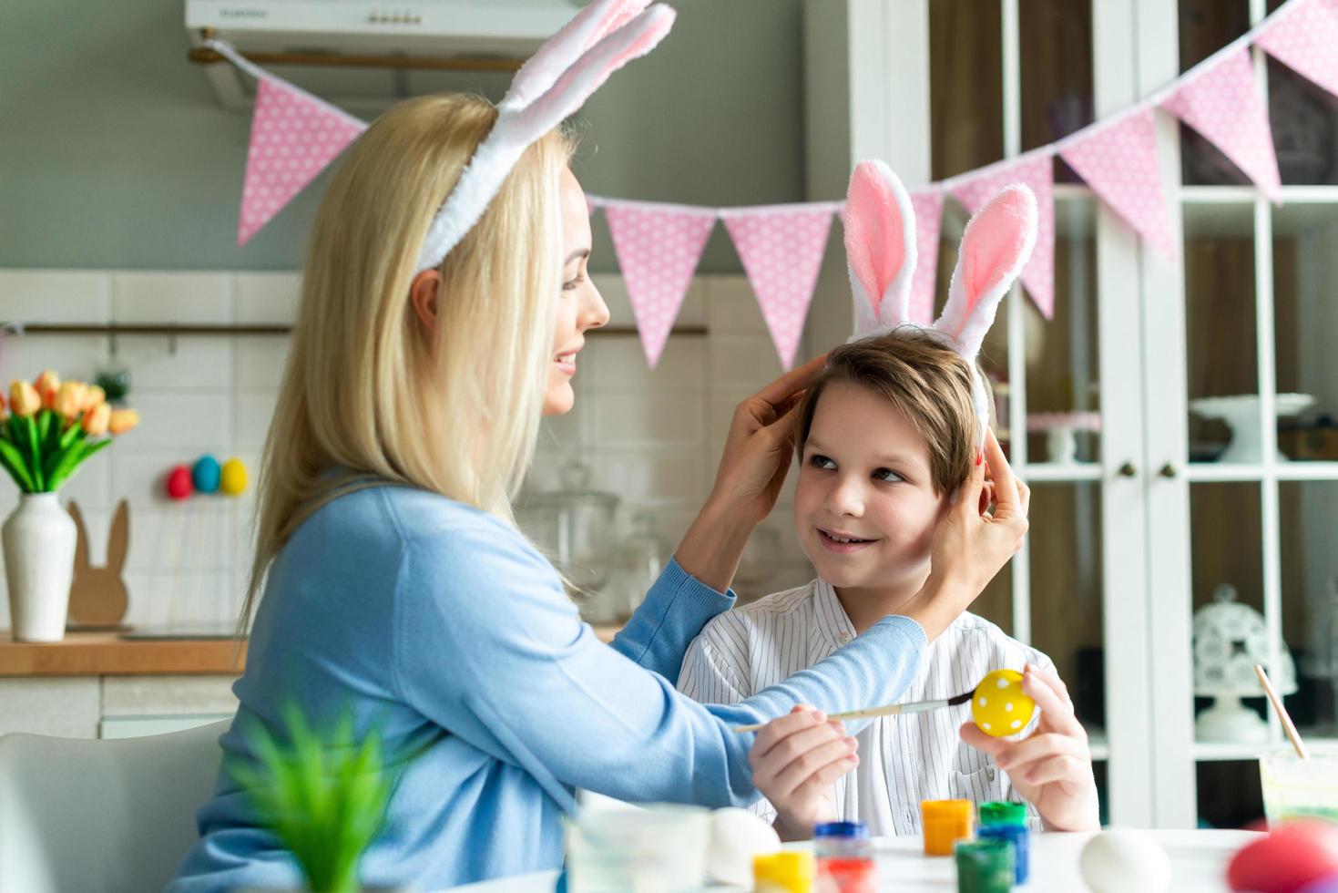 Mom trying on son son bunny Easter bunny. photo