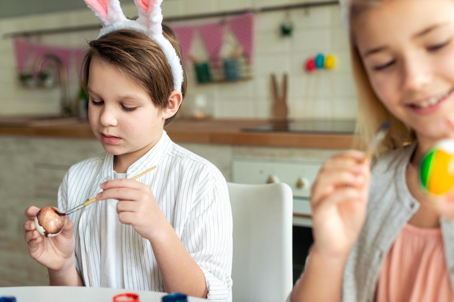 Happy kids coloring Easter eggs, preparing Easter basket photo