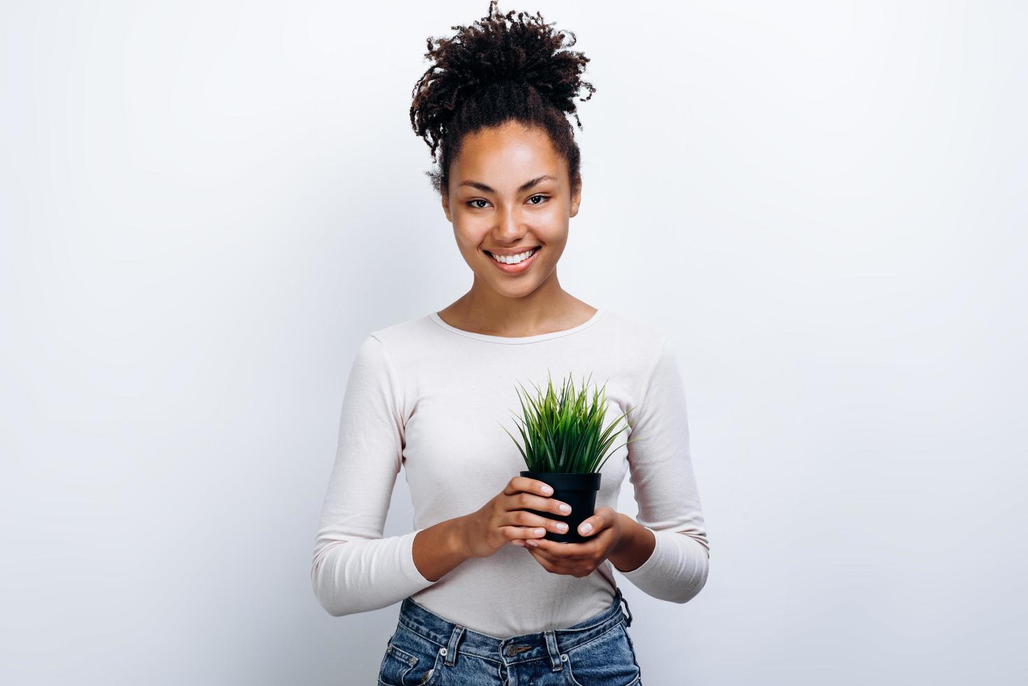 Beautiful girl holding a small flowerpot photo