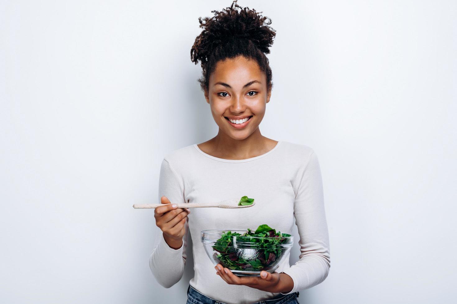 The girl poses with a homemade dish in the center on a white wall photo