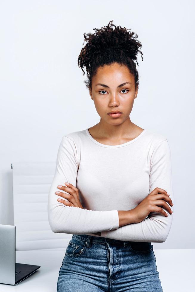 The girl crossed her arms in front of her, leaned on the table on which lay the laptop photo