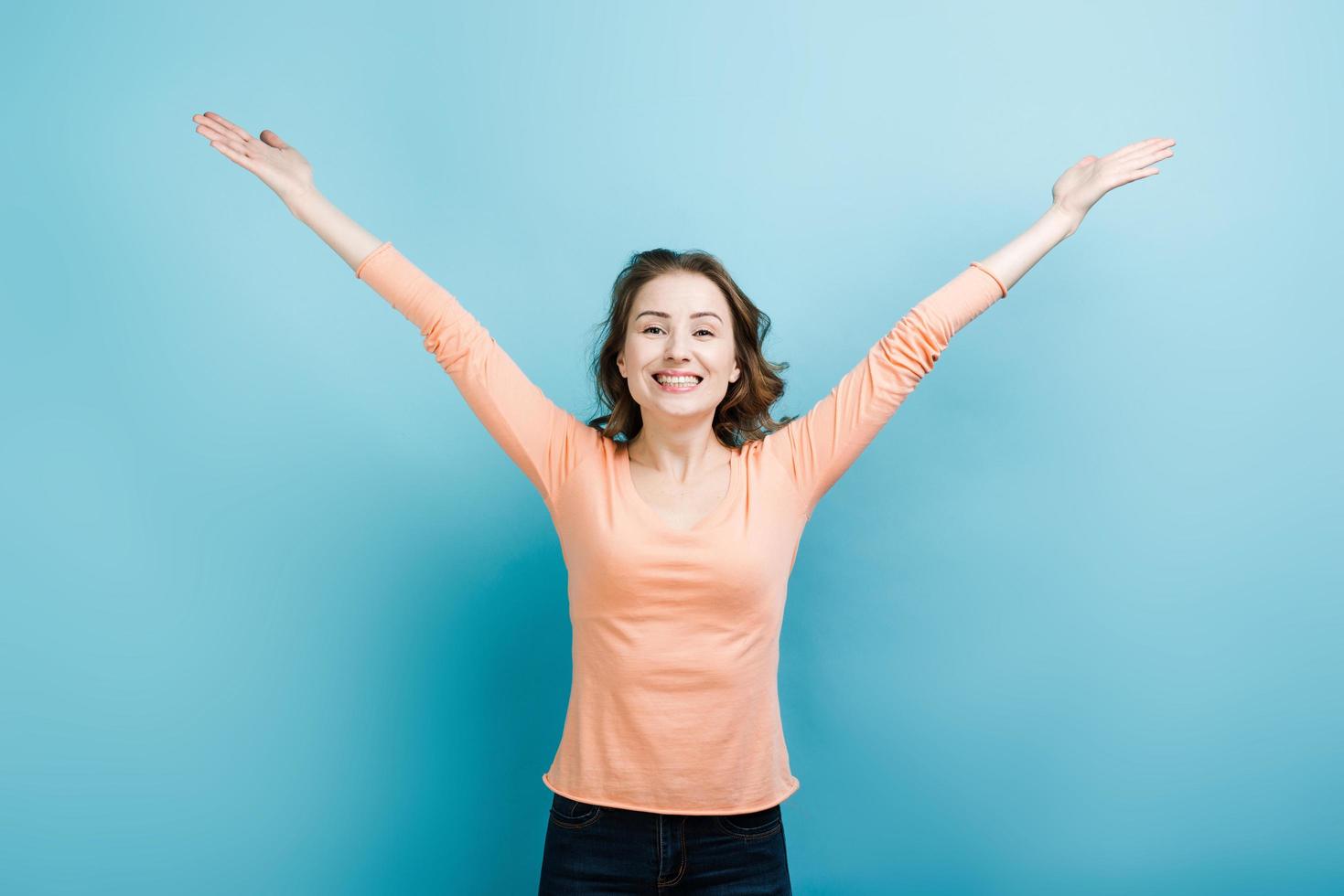 A sincere broad-smiling girl opened her arms photo