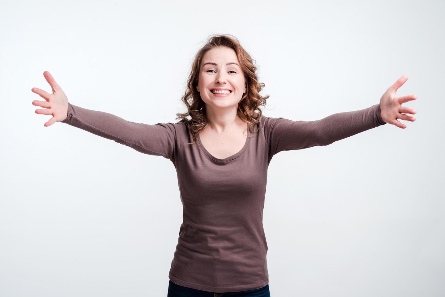Smiling happy woman waiting for hugs, congratulations. White background. photo