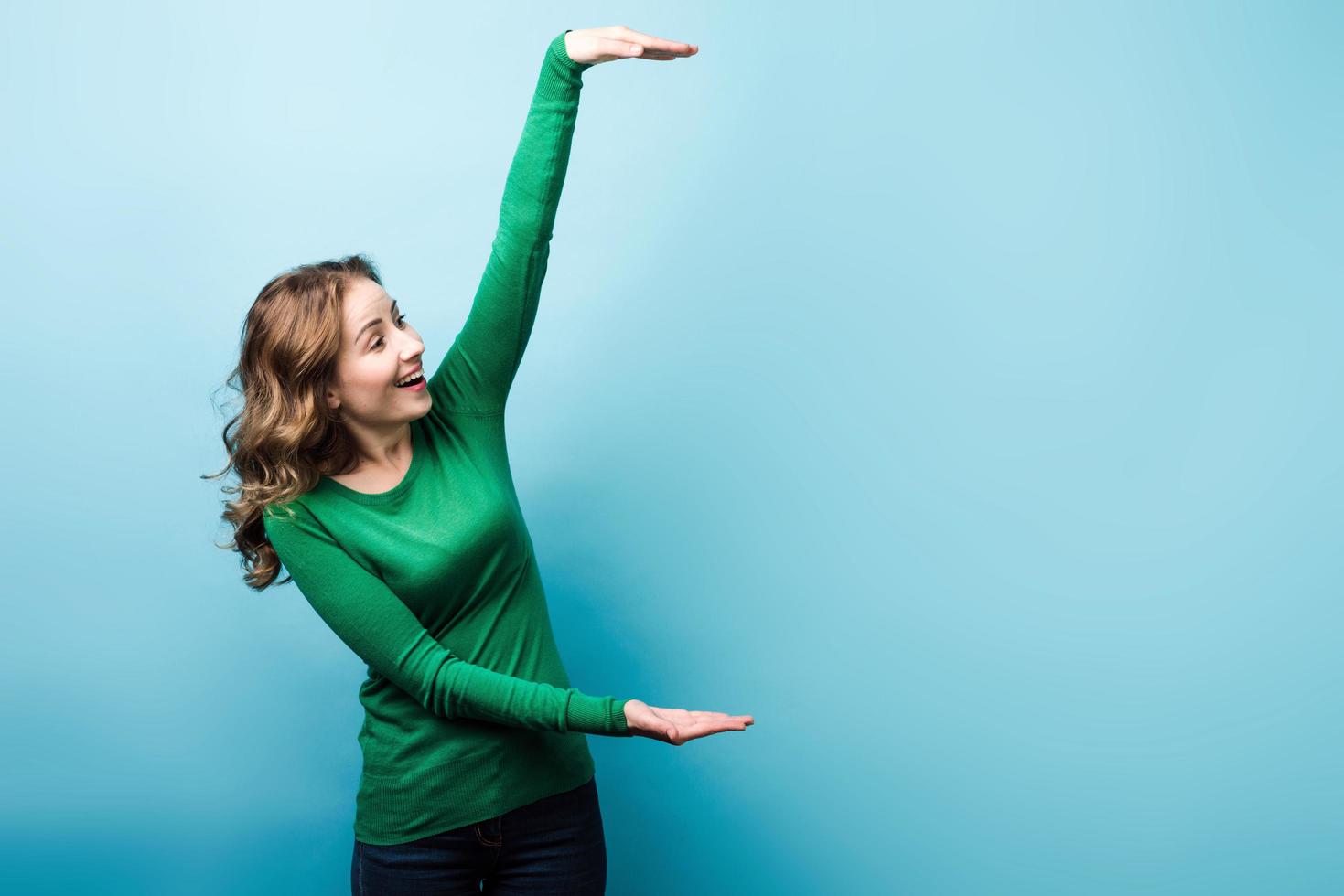 Girl holding an imaginary object, place for text. photo