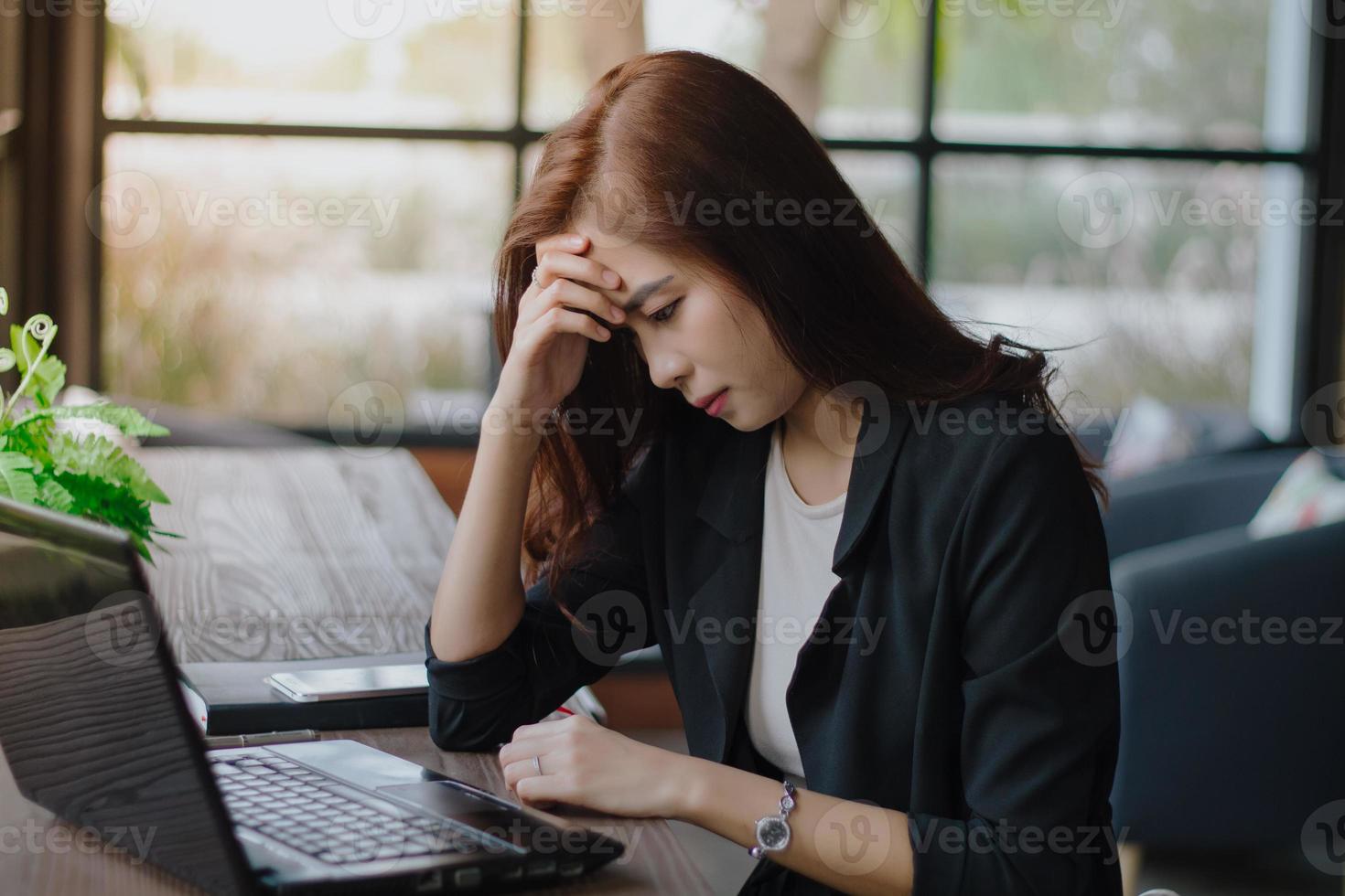 Asian businesswoman serious about the work done until the headache photo