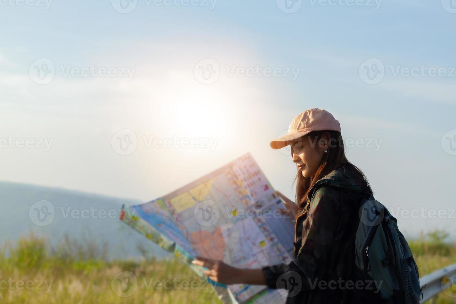 Asian  young women people Hiking with friends backpacks walking together and looking map and taking photo camera by the road and looking happy ,Relax time on holiday concept travel
