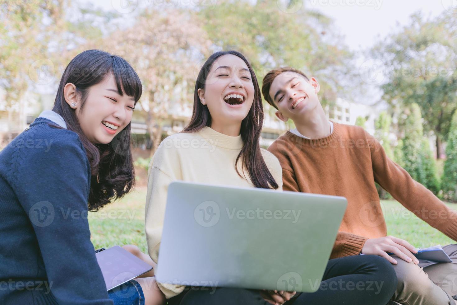 Group Students Smile and have fun It also helps to share ideas in the work and project. And also review the book before the exam in the garden. photo