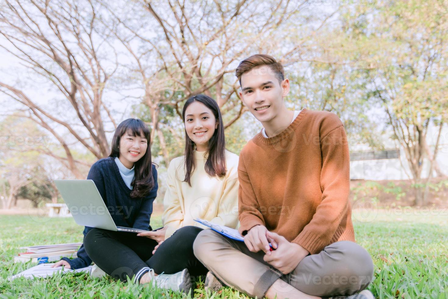 Group Students Smile and have fun It also helps to share ideas in the work and project. And also review the book before the exam in the garden. photo