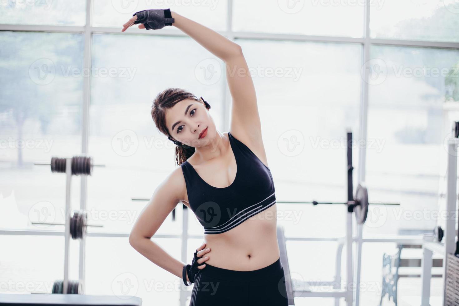 Athletic woman asian warming up and Young female athlete sitting on an exercising and stretching in a park before Runner outdoors, healthy lifestyle concept photo