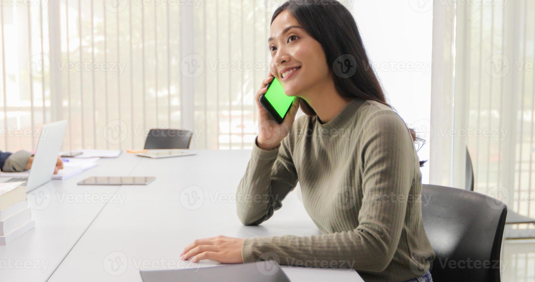 Asian women Students Smile and have fun and using smart phone and tablet It also helps to share ideas in the work and project. photo