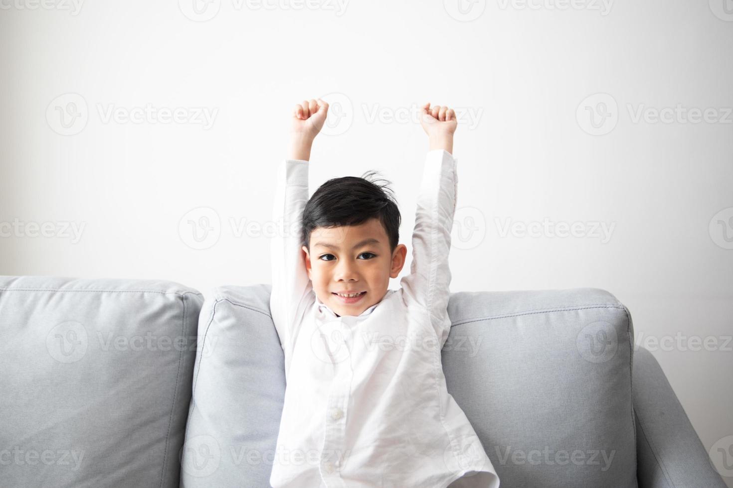 Excited and Happy family and son with arms raised while watching television at home photo