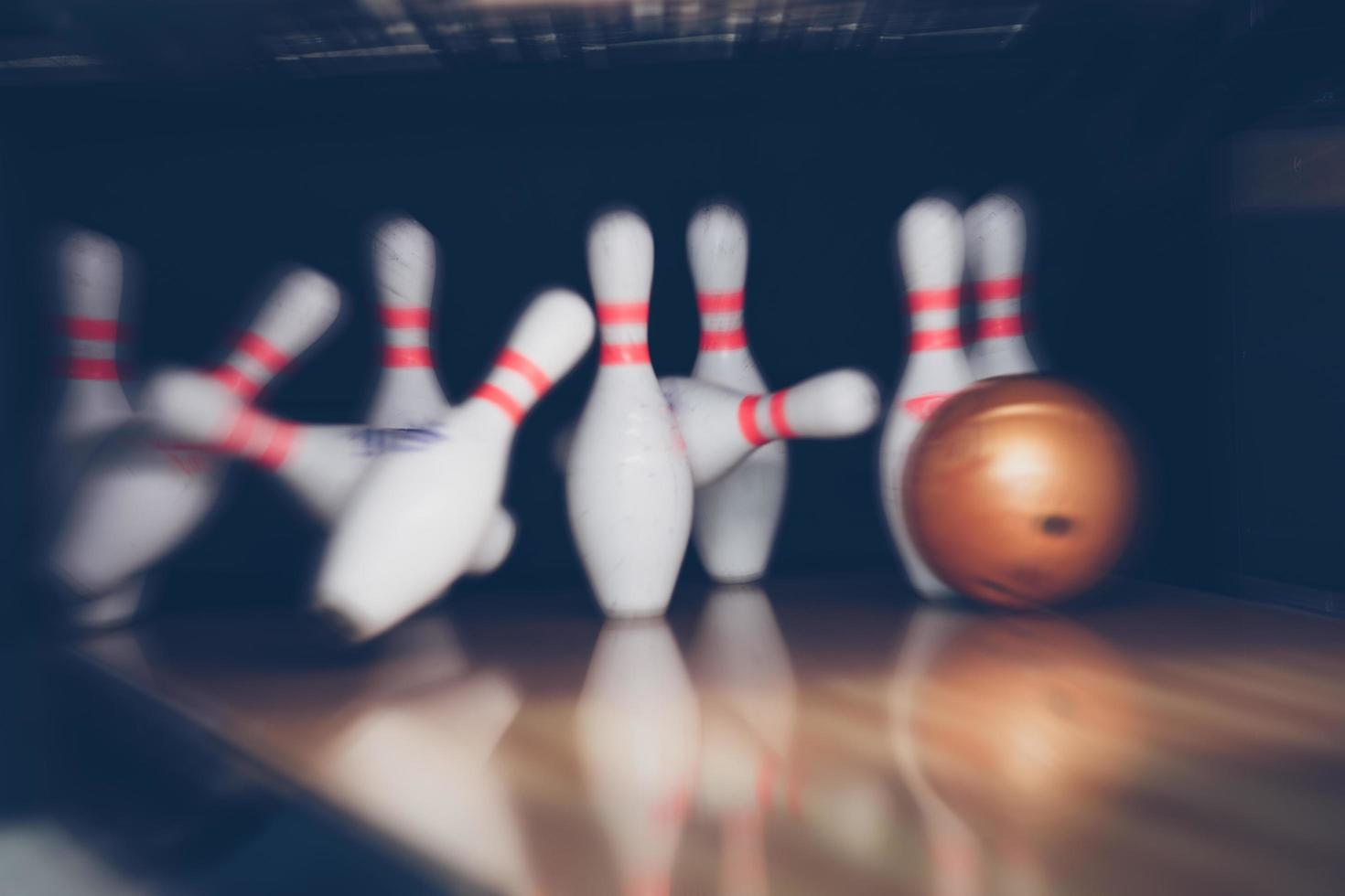 motion blur of bowling ball skittles on the playing field photo