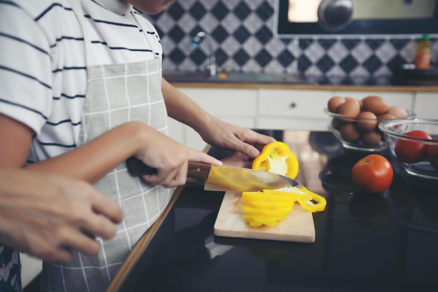 Happy Family have Dad, Mom and their little daughter Cooking Together in the Kitchen photo