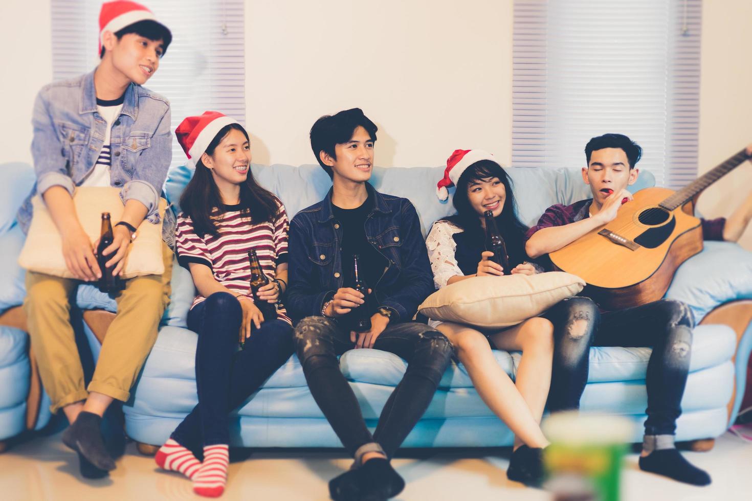 Asian group of friends having party with alcoholic beer drinks and Young people enjoying at a bar toasting cocktails.soft focus photo