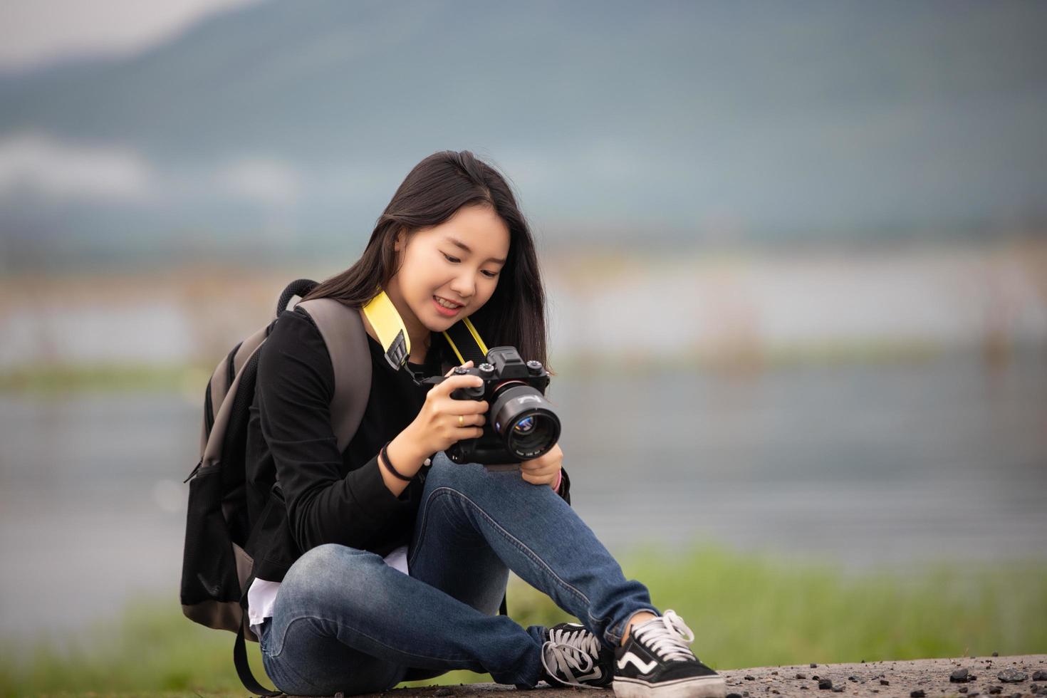 sian  young women people Hiking with friends backpacks walking together and looking map and taking photo camera by the road and looking happy ,Relax time on holiday concept travel