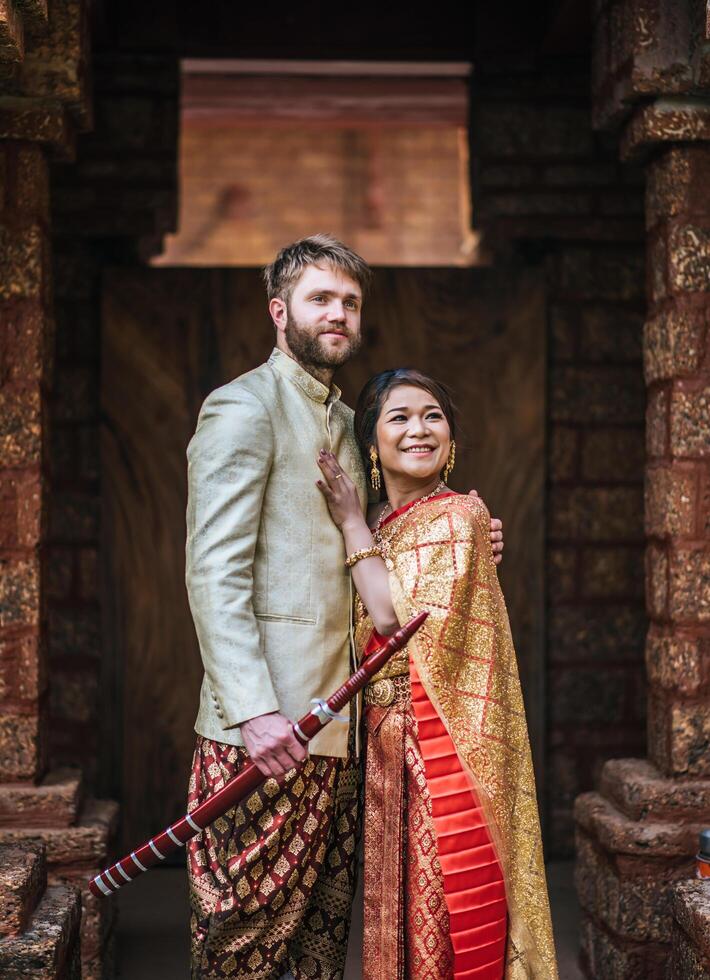 Asian bride and Caucasian groom have romantic time with Thailand dress photo