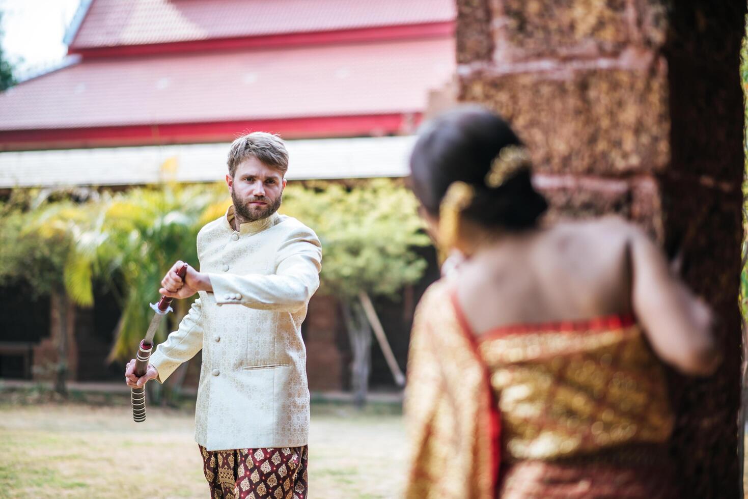 Asian bride and Caucasian groom have romantic time with Thailand dress photo