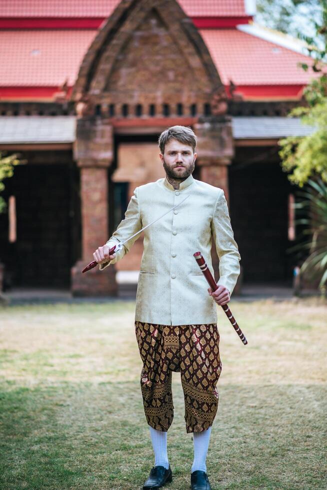 Asian bride and Caucasian groom have romantic time with Thailand dress photo