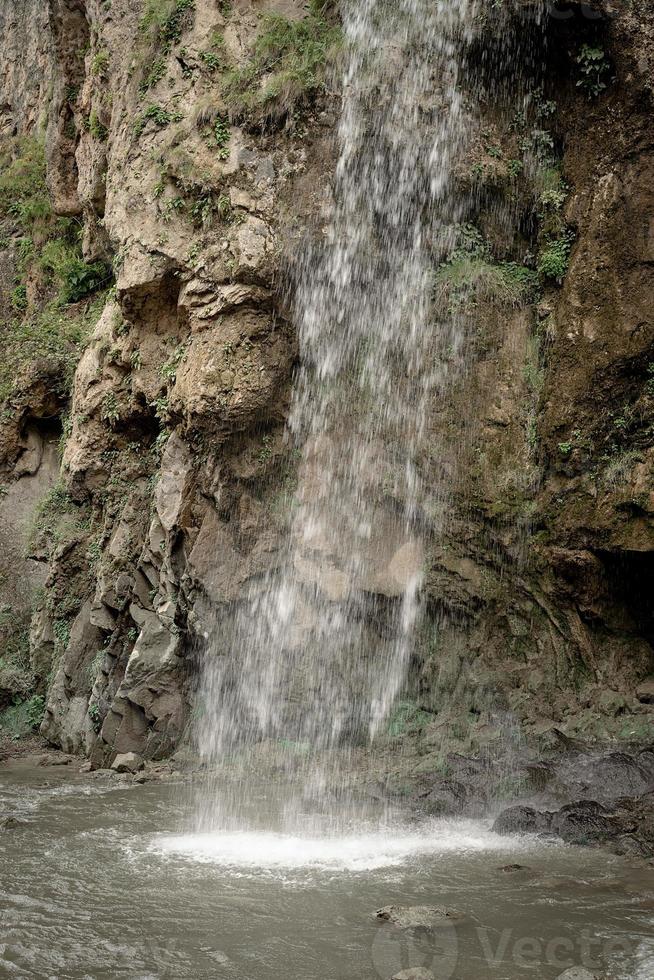 Beautiful mountain waterfall on rainy day photo