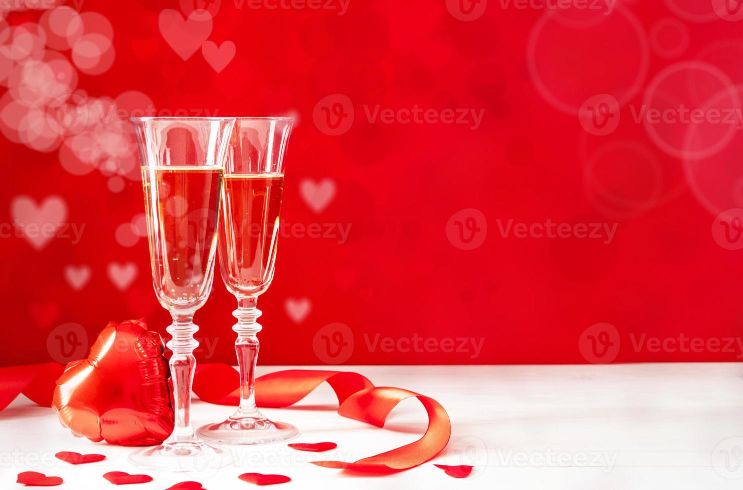 Two Champagne glasses on light bokeh background photo