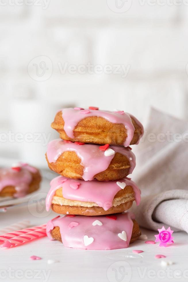 Heart shaped donut with strawberry glaze - Valentines day concept photo