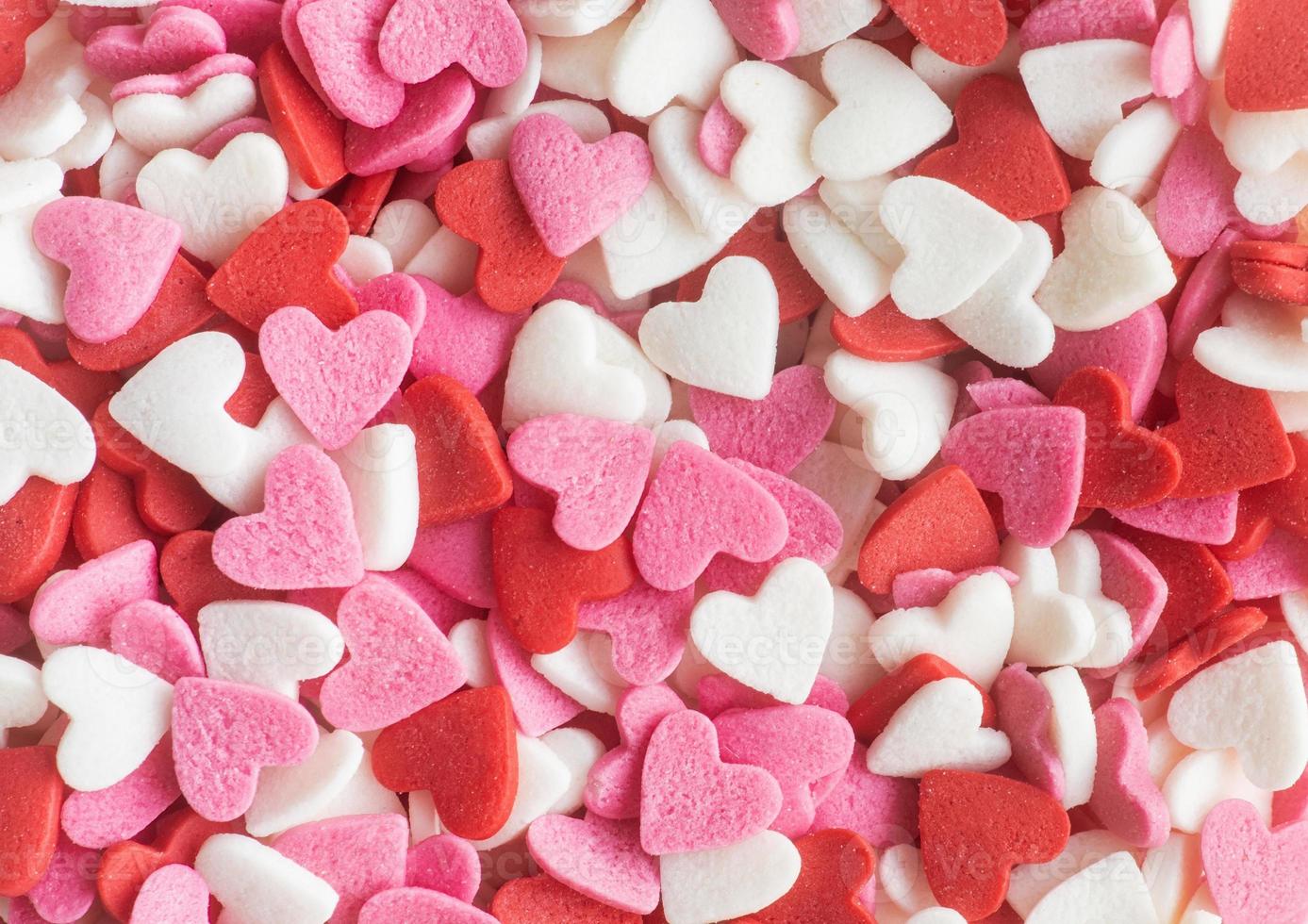 Red white and pink heart shapes sprinkles background photo