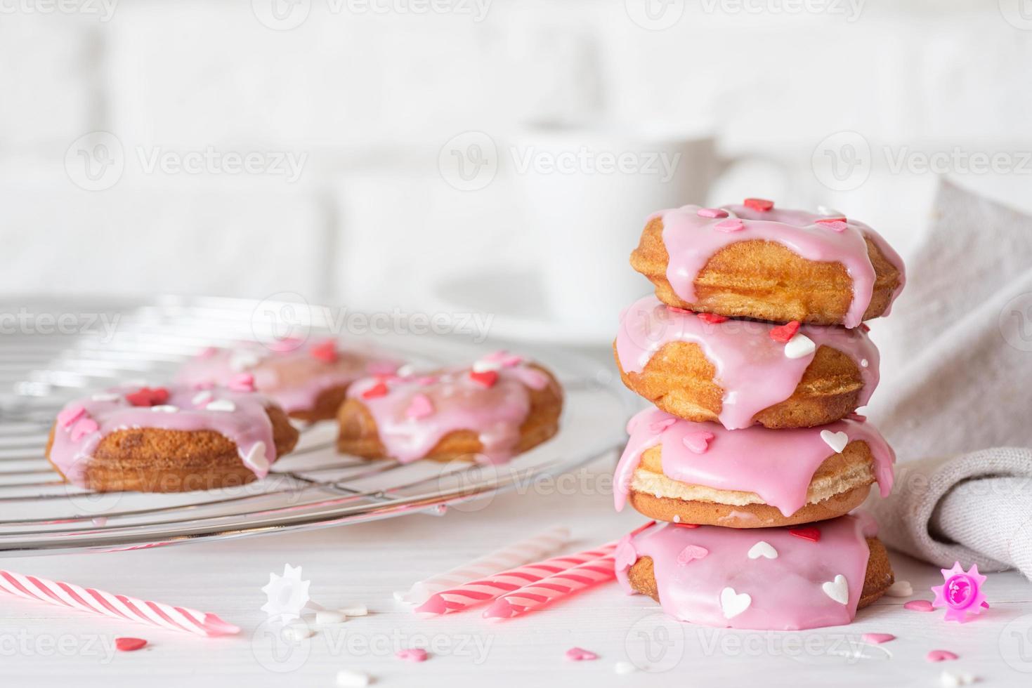 Heart shaped donut with strawberry glaze - Valentines day concept photo