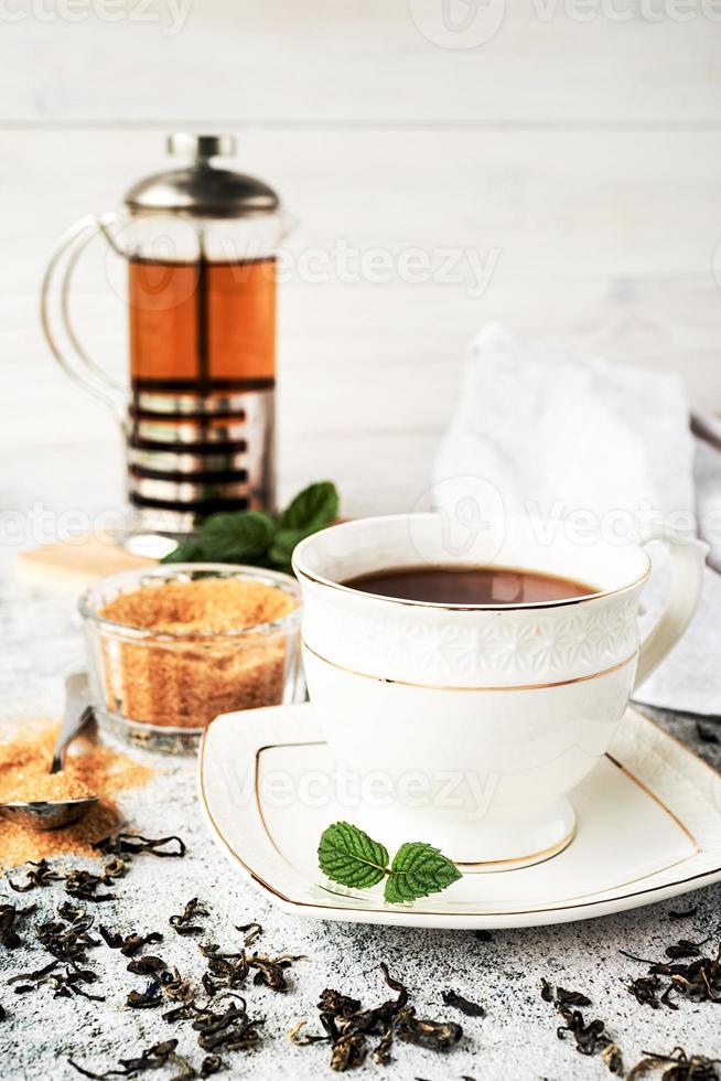 Cup tea with mint and lemon isolated on a black background. photo