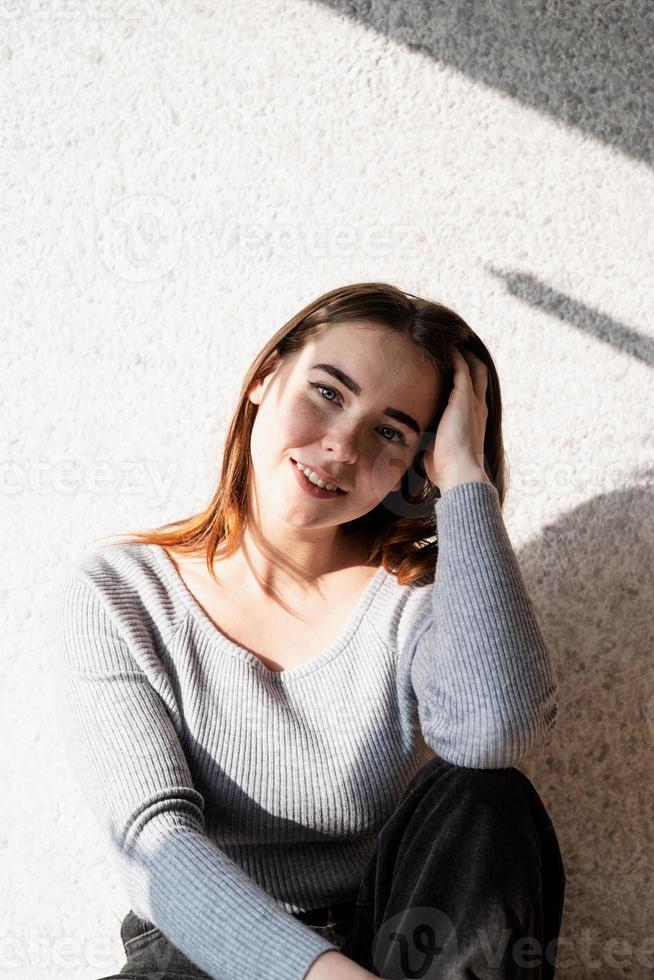 Portrait of a beautiful young woman with a shadow pattern on the face and body in the form of palm leaf photo