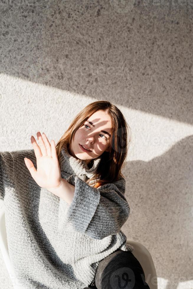Portrait of a beautiful young woman with a shadow pattern on the face and body in the form of flowers photo